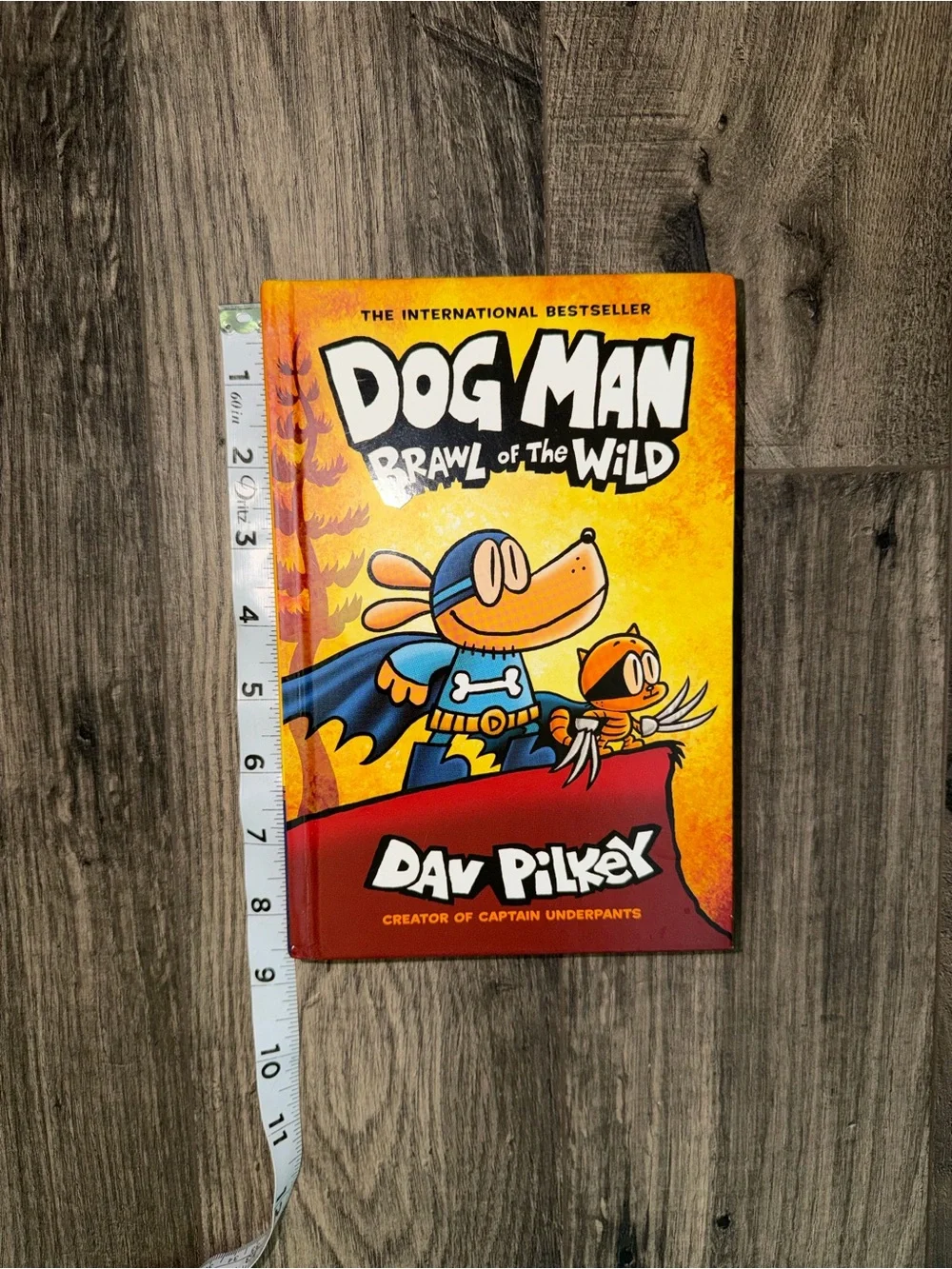 Scholastic Dog Man Hardcover with bright yellow and red cover